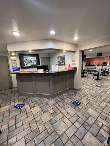 an empty lobby with a waiting room with a counter at Super 8 by Wyndham McAllen-Downtown-Airport-LA Plaza Mall in McAllen