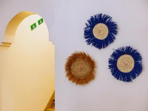 a wall with blue and brown decorations on it at Dar Iziki in Sidi Kaouki