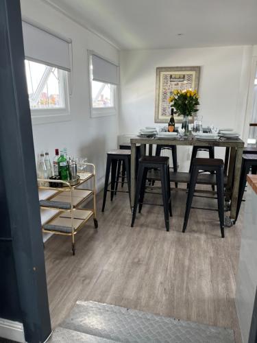 a dining room with a table and some chairs at Liverpool Waterfront Stay, excellent location , parking available in Liverpool