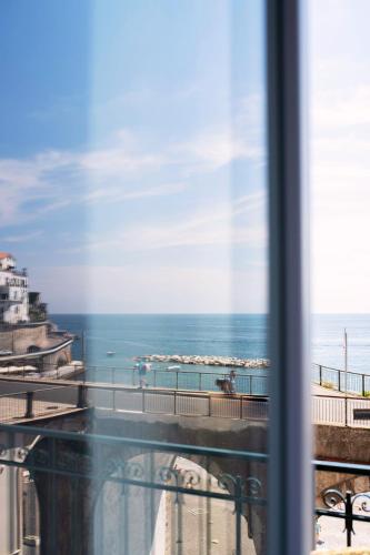 a view of the ocean from a window at Maison Escher in Atrani