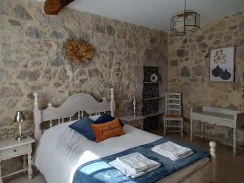 a bedroom with a bed with towels on it at Gite de Micouleau in Nérac
