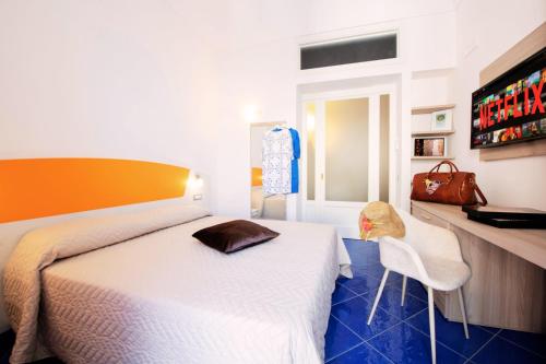 a bedroom with a bed and a table and chairs at Maison Escher in Atrani
