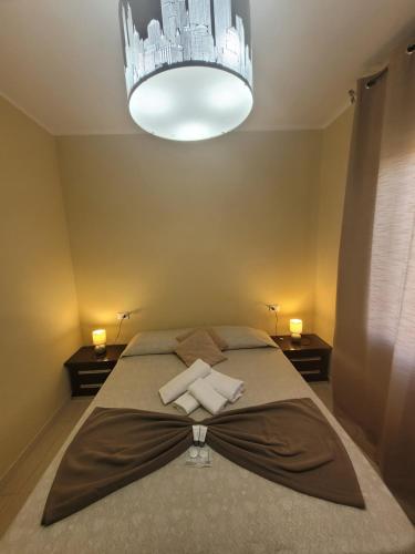 a bedroom with a large bed with a chandelier at "Fly to Venice" Airport in Tessera