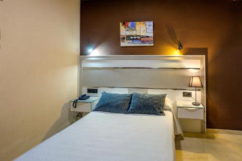Postel nebo postele na pokoji v ubytování Hotel Navarro