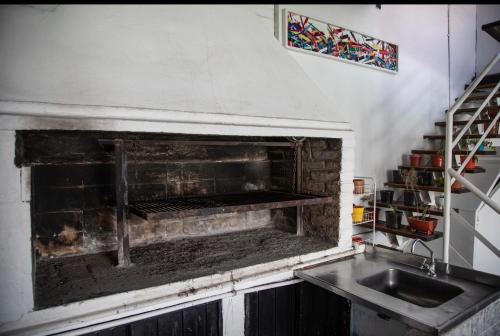a kitchen with a brick oven with a sink at Preciosa casa familiar - Piscina UBICACION GENIAL in Mendoza