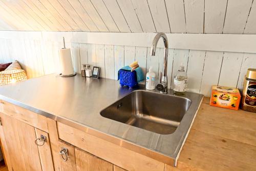 a kitchen counter with a stainless steel sink at Nyhagens trädgård och B&B 