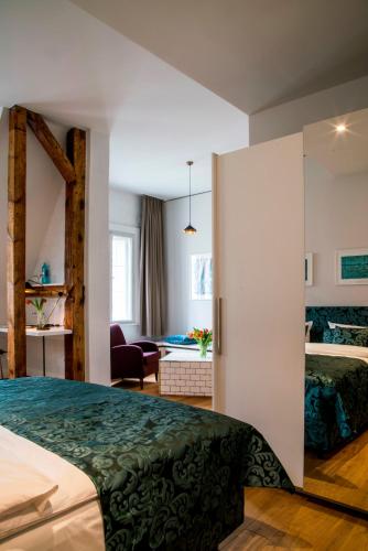 a hotel room with a bed and a living room at Hotel Oderberger in Berlin