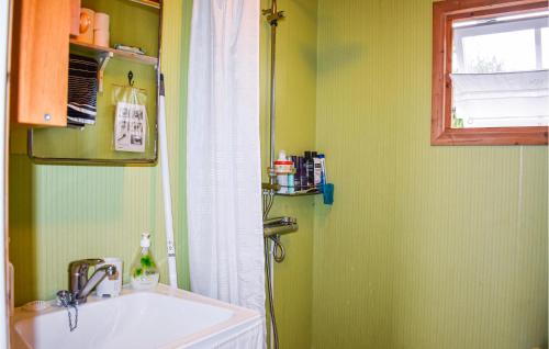 a bathroom with a sink and a window at 3 Bedroom Lovely Home In Ronneby in Ronneby
