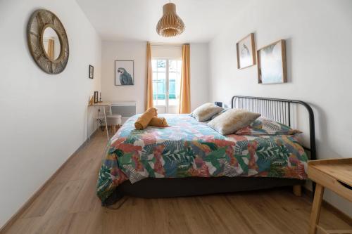a bedroom with a bed with a teddy bear on it at Résidence Epinat - Appartements centre & parking in Vichy
