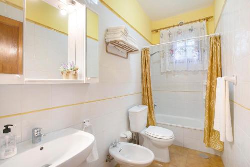 a bathroom with a white toilet and a sink at Finca Imoses Bailon in Santa Cruz de Tenerife