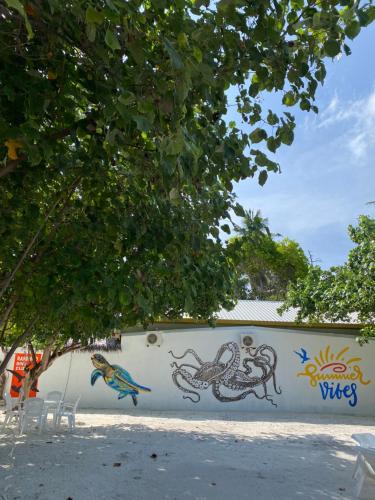 a wall with a mural of crabs and a bird at Summer Vibes Beach Front in Rasdu