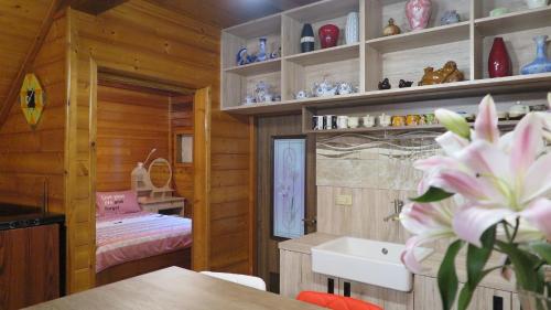 a room with a bedroom and a room with a bed at 秋憶木屋 in Gukeng
