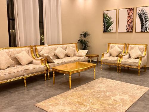 a living room with two couches and a coffee table at Pool Villa Saraya in Ras al Khaimah