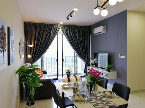 a dining room with a table and chairs and a large window at Astetica Residences @ Seri Kembangan in Seri Kembangan