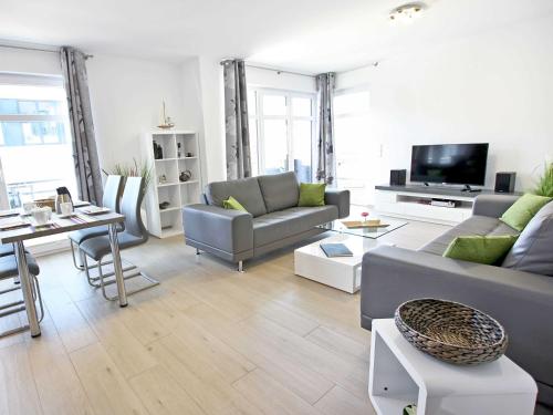 a living room with two couches and a tv at Villa Louisa - Wohnung 51 in Ostseebad Sellin