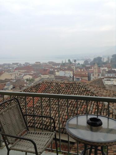 a table and chairs on a balcony overlooking a city at Amfitriti Palazzo in Nafplio