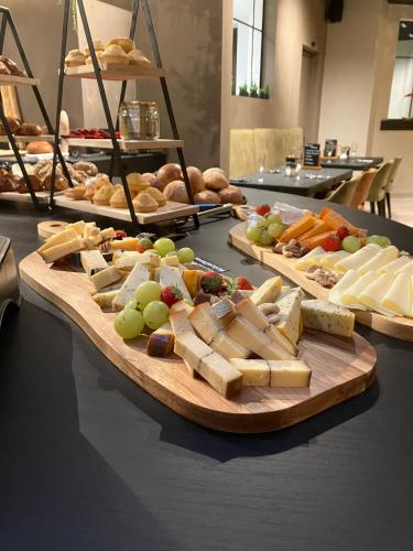 a table with different types of cheese and other foods at B&B Herenhuis in Izegem