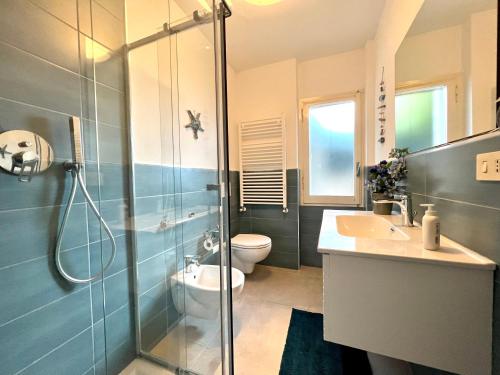 a bathroom with a shower and a toilet and a sink at VILLA BLUE PANORAMIC PORTOVENERE in Portovenere
