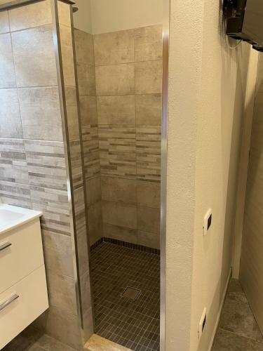 a shower with a glass door in a bathroom at Casa Camere Pistis in Assemini