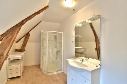 a bathroom with a glass shower and a sink at Gite Mont Saint Michel "AUCOEURDELABAIE" in Sains