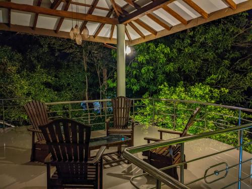 a patio with chairs and a table on a deck at Choona Lodge 'view of sigiriya & pidurangala with sunrise' in Sigiriya