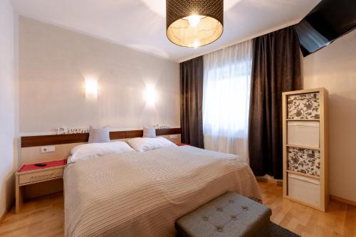 a bedroom with a large bed and a window at Apartment Steindl in Längenfeld