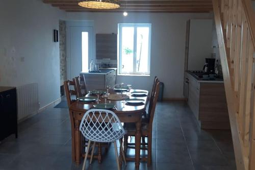 une salle à manger avec une table et des chaises dans une cuisine dans l'établissement Marquise, gîte chaleureux, le coeur de la famille, à Marquise