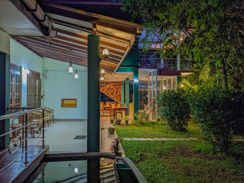 a view of the outside of a house at night at Choona Lodge 'view of sigiriya & pidurangala with sunrise' in Sigiriya