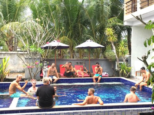 a group of men sitting in a swimming pool at Wahyu Homestay 1 in Nusa Lembongan