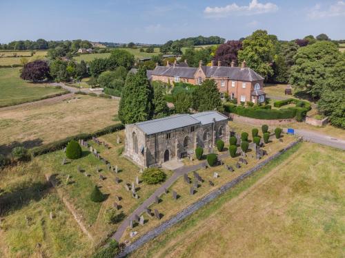 an aerial view of an old building in a field at Yew Tree Nook in Ashbourne