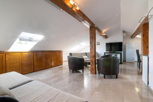 a room with a bed and chairs and a kitchen at Beachfront apartments Calm Sea in Preko