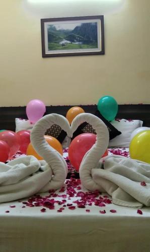 a table with balloons and a cake with the number at Seven Hills Shimla by Him Haults Hospitality in Shimla