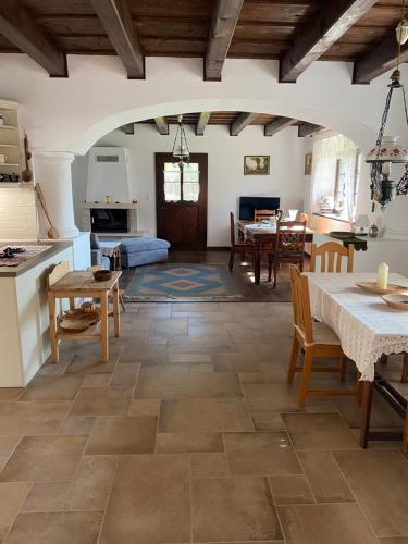 a kitchen and living room with a table and chairs at A nyugalom háza in Szentbékkálla