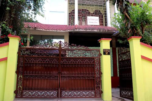 a red gate in front of a house at Urbanica Homestay in Guwahati