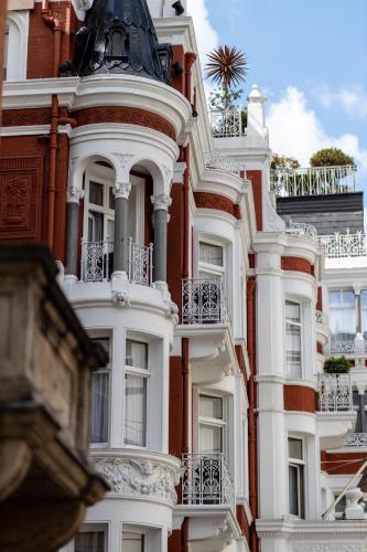 a tall white building with balconies on it at Althoff St James's Hotel & Club London in London