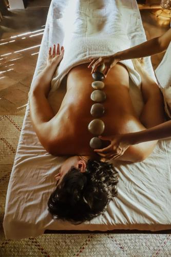 a naked woman laying on a bed with beads at Pousada Recanto da Grande Paz in Alto Paraíso de Goiás