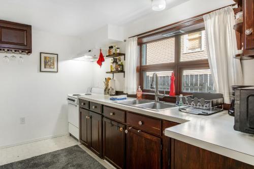 a kitchen with a sink and a stove and a window at Hidden Gem in Green Lake in Seattle