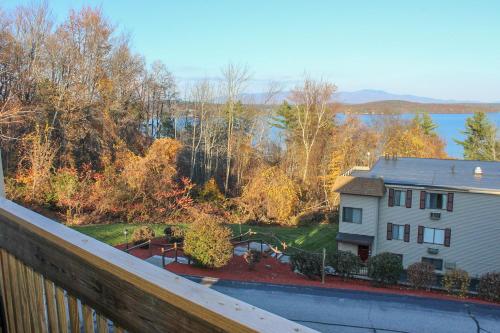 a view from a balcony of a house and a yard at Tree Top Getaway in Laconia