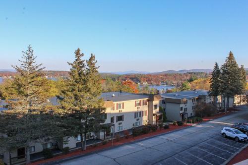 an aerial view of a apartment complex with a parking lot at Tree Top Getaway in Laconia