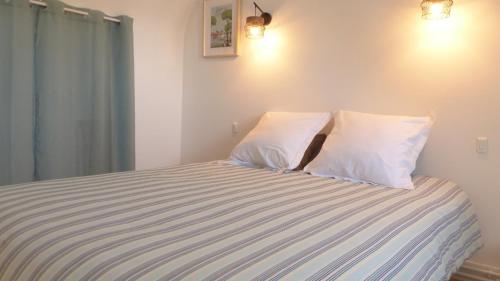 a bedroom with a bed with two pillows at Maison médiévale de charme à Baden in Baden