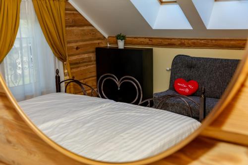 a bed and a chair in a room at Villa Rose & SPA in Mežciems