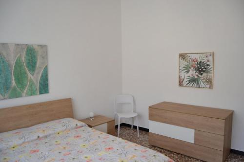 una camera con letto, cassettiera e sedia di Casa Rosetta a Noli