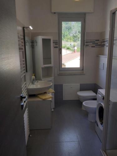 bagno con lavandino, servizi igienici e finestra di Casa Rosetta a Noli