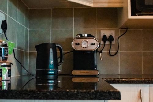 a coffee maker on a counter in a kitchen at The Aloes Farm - The Studio & The Gallery in Hilton