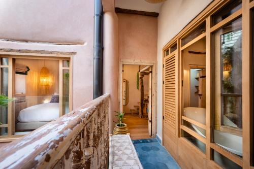 a balcony with a bedroom and a bed at Mama Lova Hôtel, Riad, Restaurant & Spa in Essaouira
