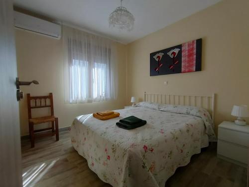 a bedroom with a bed with a bag on it at Casa Rural Santa Bárbara in El Real de San Vicente