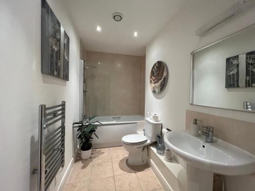 a bathroom with a toilet and a sink at Stunning City Centre Apartment, Benson Street, Liverpool 1 in Liverpool