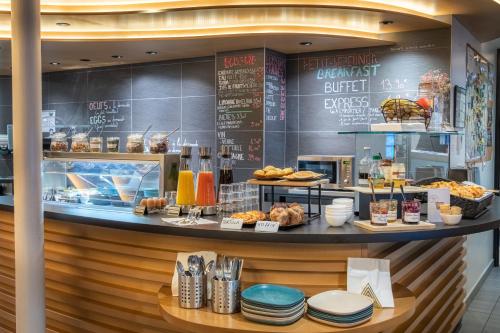 a bakery with a counter with pastries and bread at Urban Bivouac Hotel in Paris