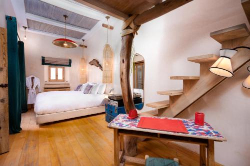 a bedroom with a bed and a staircase in a room at Mama Lova Hôtel, Riad, Restaurant & Spa in Essaouira