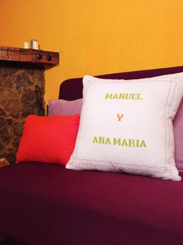 a pillow with the name of anarma maratha sitting on a bed at Casa Manuel y Ana María. in Llombera